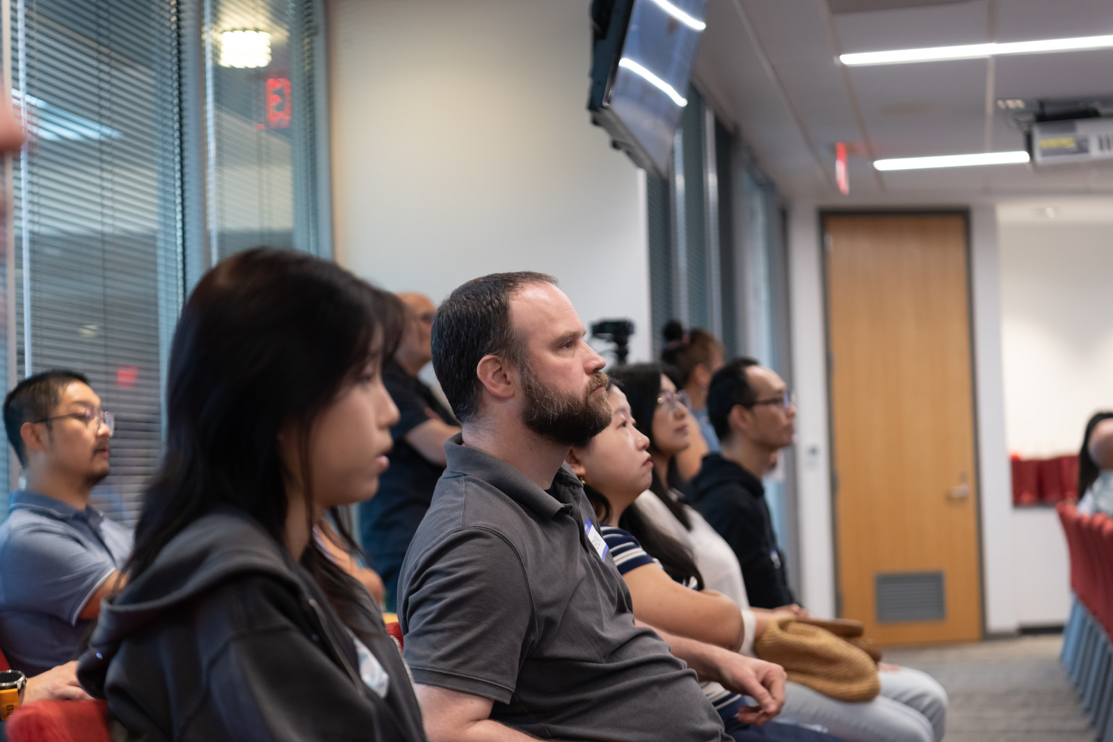 A profile view of attentive attendees during a talk.