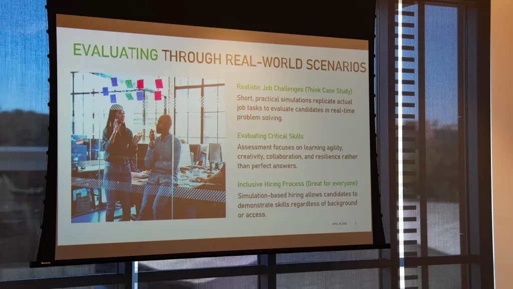 A slide titled 'Evaluating Through Real-World Scenarios' on simulation-based, inclusive hiring.