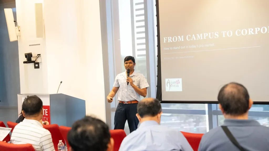 A presenter delivers the 'From Campus to Corporate' session on standing out in today's job market.