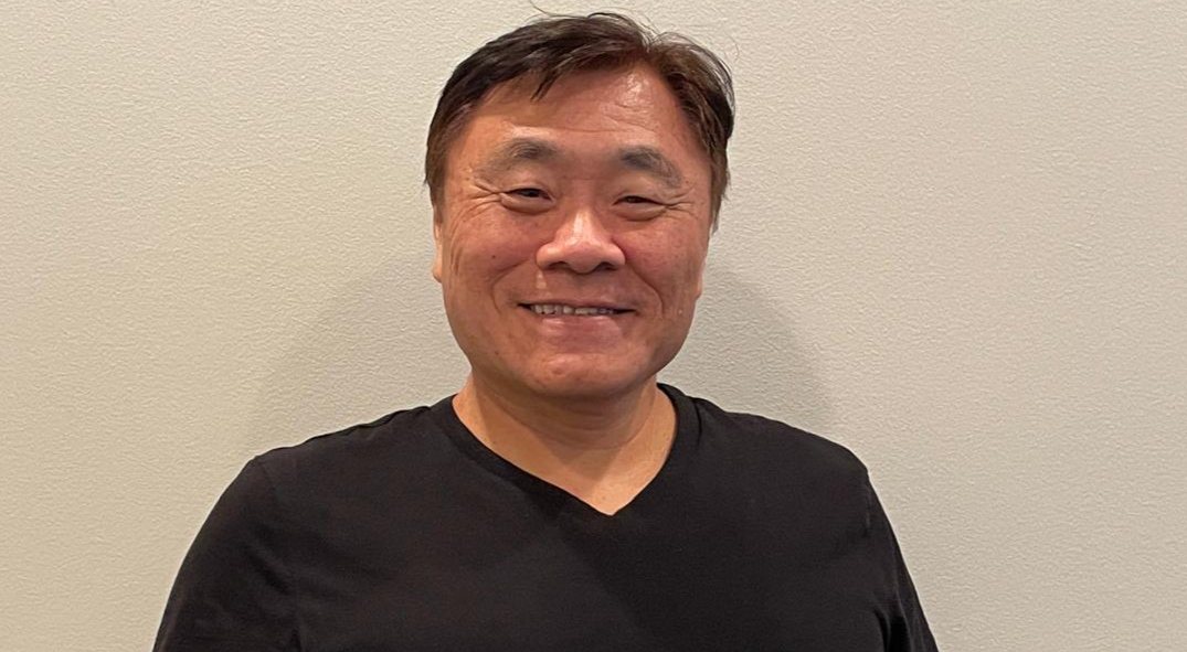 A community member smiling at an Asian Focus event